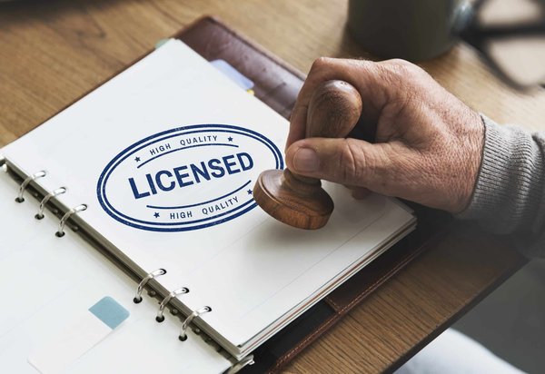 What are the specific steps for a UK business to obtain a music venue license?